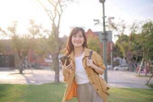 Asian woman using smartphone in park photo