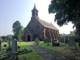 A church with a steeple at Coddington photo