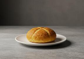 A baked bread on a plate on a table photo