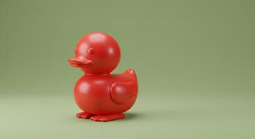 A red duck toy on a green background photo