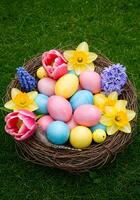 A basket of colorful eggs on the grass photo