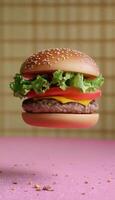 Burger fast food with lettuce, tomato, cheese and beef floating with brown background photo