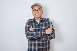 Mechanic Asian man fixing repairing car engine automobile vehicle parts examining screwing using tools wrench equipment working hard in workshop garage support and service in overall work uniform photo