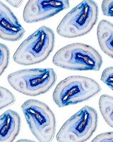 Pattern of blue agate crystals isolated on white background, top view natural slices beautiful gemstone as abstract flat lay. Agate stone healing crystal, minimal layout photo