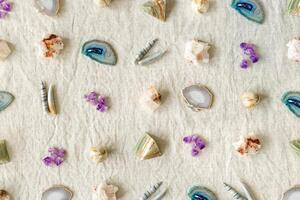 top view Pattern of crystals on table, healing minerals agate, quartz, amethyst, onyx, semiprecious gem. Stones for stone therapy, lithotherapy, rocks for ritual. Top view, minimal flat lay photo