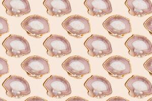 Pattern of agate crystals isolated on beige background, natural slices beautiful gemstone. Agate stone healing crystal, minimal style layout, flat lay beige pink pastel color photo