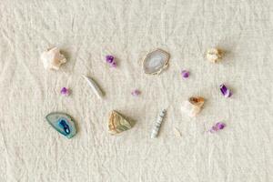 Pattern of crystals on table, healing minerals agate, quartz, amethyst, onyx, semiprecious gem. Stones for stone therapy, lithotherapy, rocks for ritual. Top view, minimal flat lay, photo