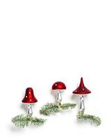 Christmas botanical ornaments fly agaric mushrooms with red cap and white dots, on natural green christmas fir tree branches on white background with copy space. Holiday winter decor photo