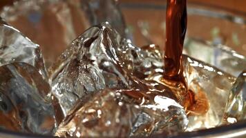 Cola is poured into a glass with ice. Filmed on a high-speed camera at 1000 fps. High quality FullHD footage video