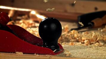 A carpenter is working on a wooden surface with a plane. Filmed on a high-speed camera at 1000 fps. High quality FullHD footage video