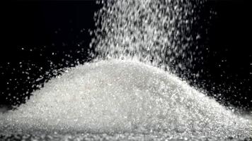 Sugar falls on the table in a heap. Filmed on a high-speed camera at 1000 fps. High quality FullHD footage video