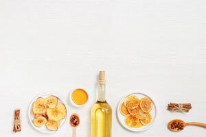 Composition with ingredients hot winter drink mulled wine, white wine, dried oranges and apples, sweets or lollipops photo
