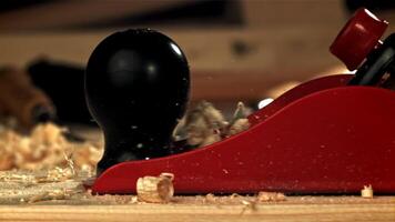 A carpenter is working on a wooden surface with a plane. Filmed on a high-speed camera at 1000 fps. High quality FullHD footage video