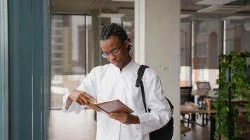 Medical intern reading textbook in university hallway video