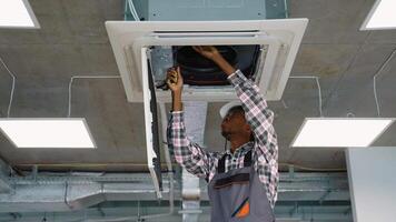 Technician fixing ceiling air conditioning unit video