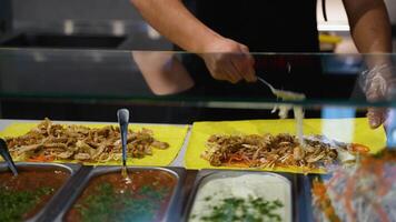 Assembling Shawarma Wraps with Meat and Sauce video