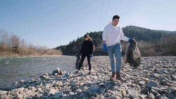 Duo Sorting Garbage in Nature During Cleanup video