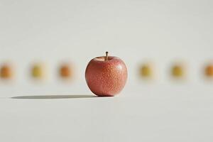 Single, fresh apple, in focus, with blurred apples in background photo