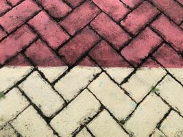 a brick sidewalk with red and white stripes photo
