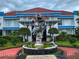 fish statue with fountain in front of fisheries building. Indonesia - Sibolga, April 14, 2025 photo