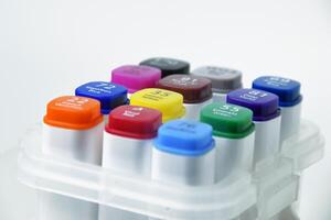 Top View of Colorful Markers with Caps on White Background for Creative Projects photo