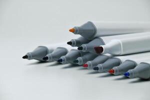 Open markers neatly arranged on white background photo