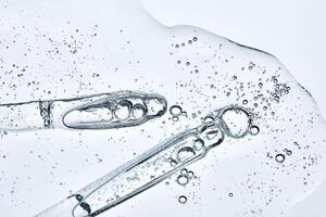 Delicious texture of the serum with bubbles. View from below on a light background. photo