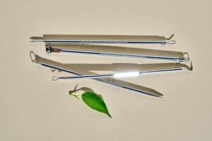 Tools for mechanical facial cleansing at home or at a cosmetologist on a beige background. photo