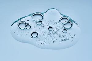 A drop of gel serum with bubbles. The texture. View from below. photo