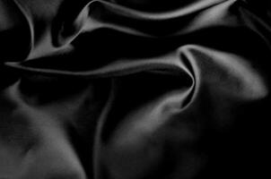 Top view of dark fabric showing smooth texture. Suitable for design and wallpaper background photo