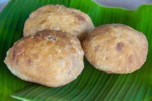 Side view of North Borneo home made traditional green bean cake with banana leaf background. Asian food concept photo