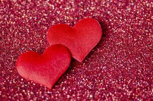 Tiny red hearts on sparkle red background with customizable space for text or wishes photo