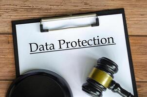 Data Protection text on white paper clipboard with gavel photo