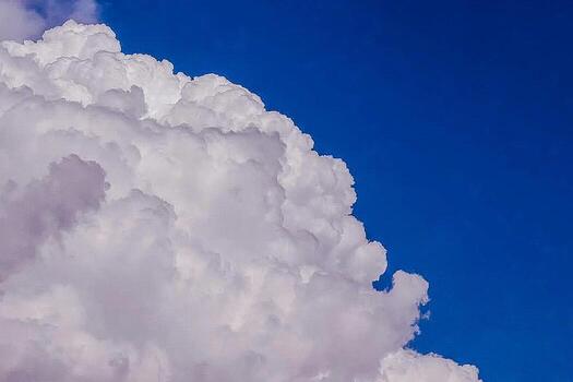 Fluffy Cumulus Cloud Against a Deep Azure Sky, a Weather Phenome photo