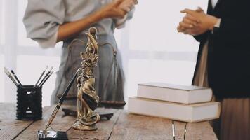Two people standing at a desk with a statue of a justice of the peace video