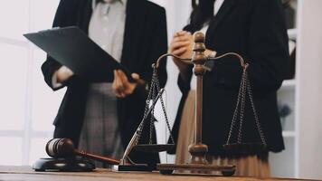 Two business people standing in front of a judge's desk video