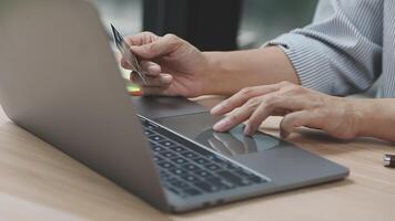 A person using a credit card on a laptop video