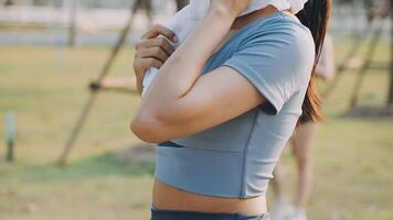 A woman is standing in the grass with her head covered video