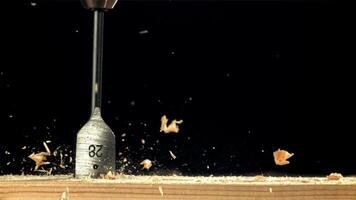 A carpenter drills a hole in a wooden product. Filmed on a high-speed camera at 1000 fps. High quality FullHD footage video