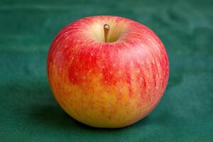 a red apple on a green cloth photo