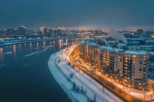 a city at night with a river and buildings photo