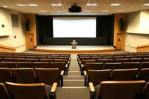 a large auditorium with empty seats and a projector screen photo