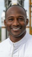Smiling african american aerospace engineer posing in front of rocket photo