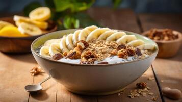 Banana and granola breakfast bowl on wooden table photo