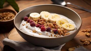 Yogurt with bananas, raspberries and granola on a wooden table photo