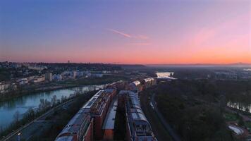 Modern rooftops and riverbanks at sunset in Lyon, France video