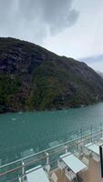 Turquoise fjord waters and forested cliffs seen from cruise ship in Patagonia video