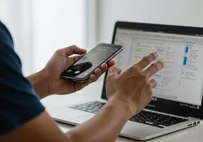 Businessman Using Smartphone and Laptop for Business Work photo