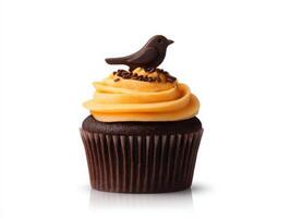 A chocolate cupcake with a bird on top photo