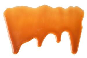 Dripping Melted caramel sauce abstract drops on white background photo